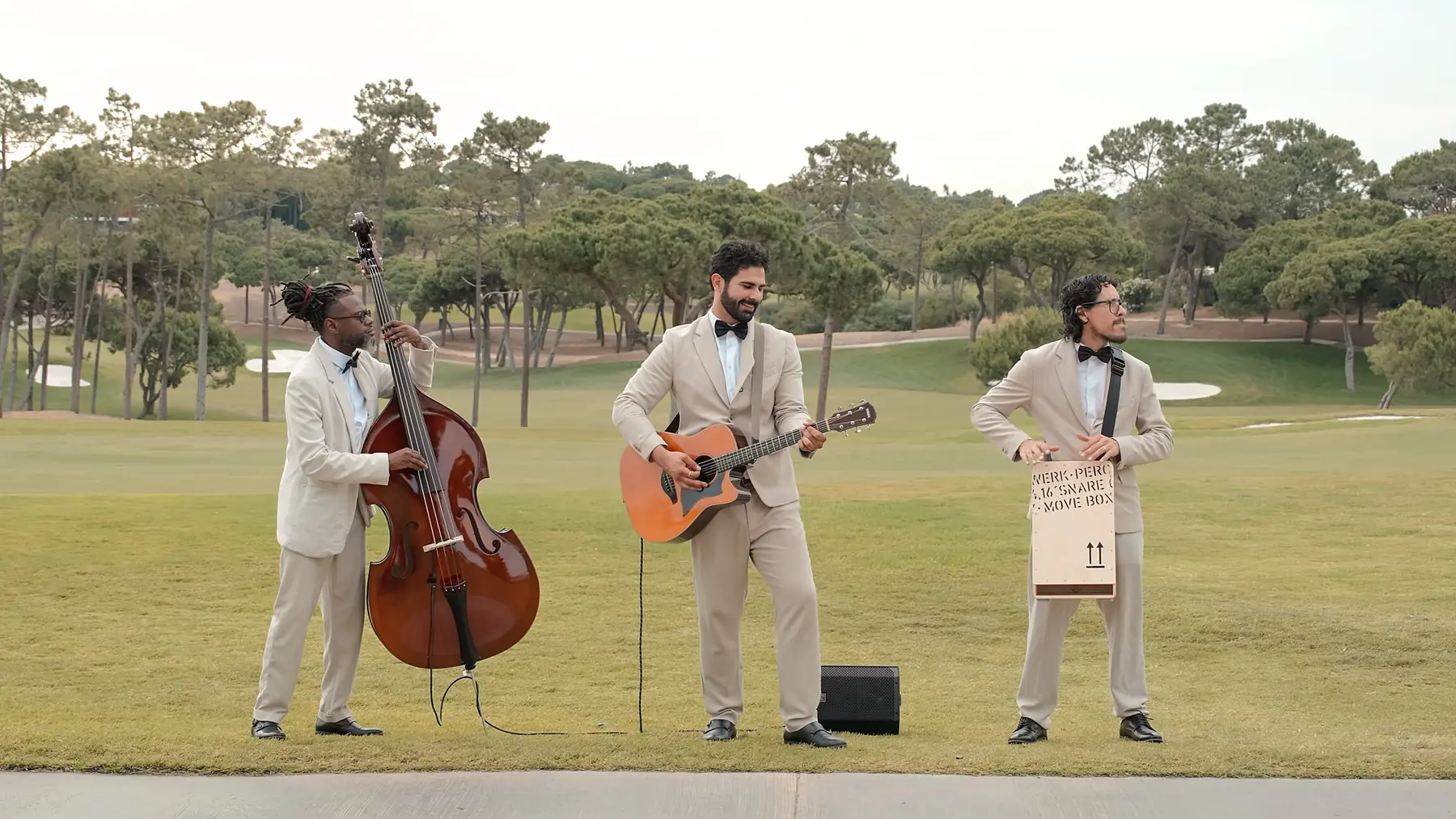 Roaming trio performing outdoors in natural light