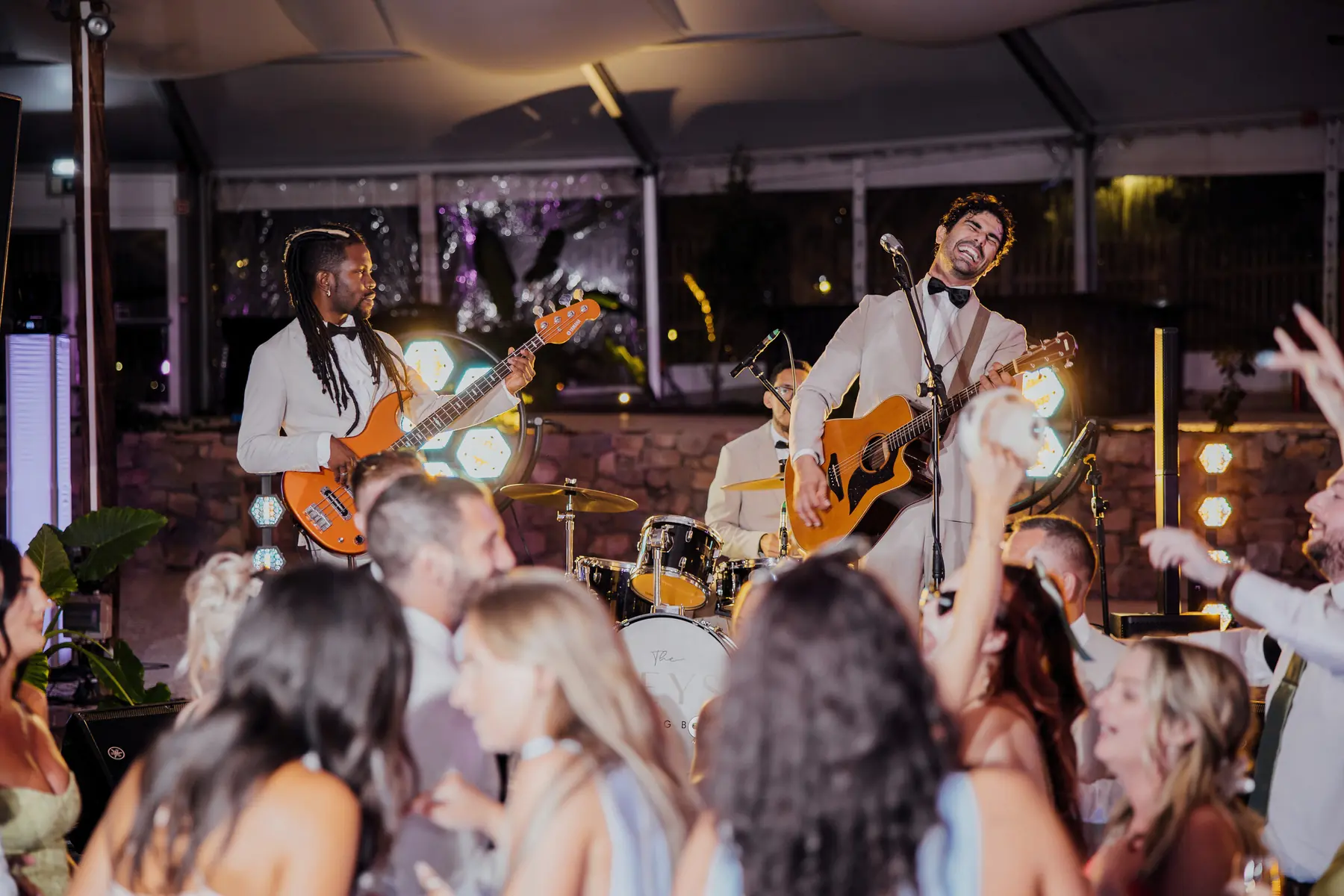 Band performing for guests inside a marquee