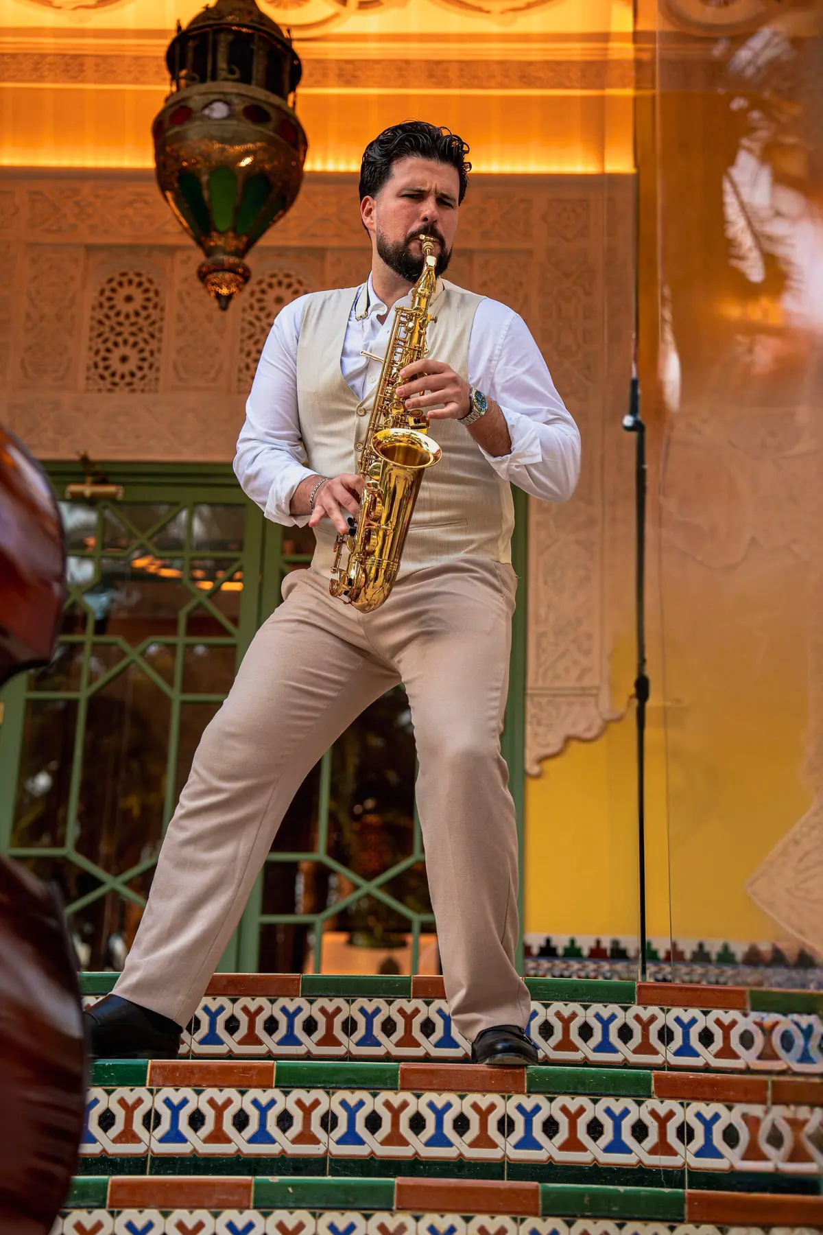 Saxophonist performing on ornate tiled steps