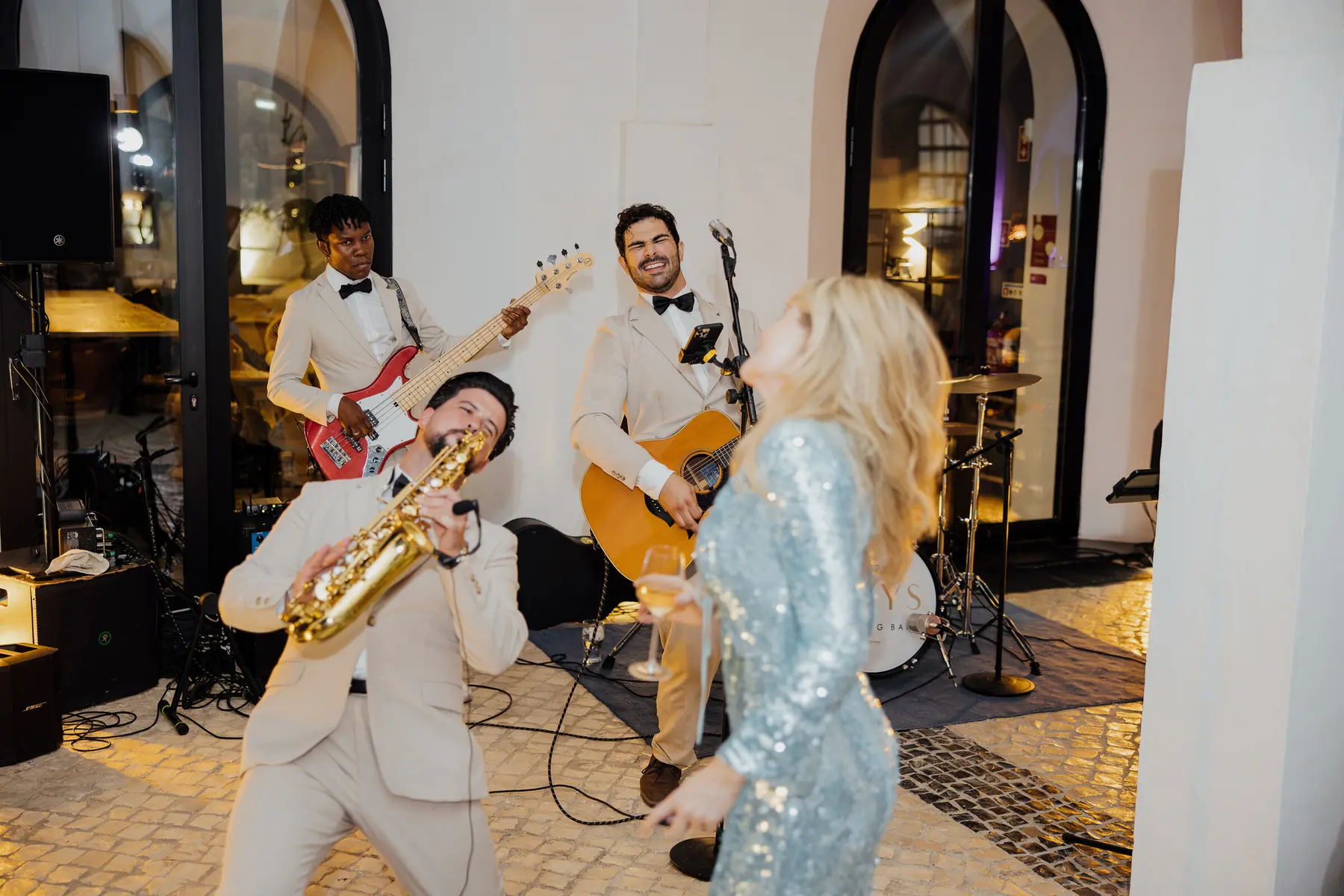 Saxophonist and guitarist performing with the bride on the dance floor