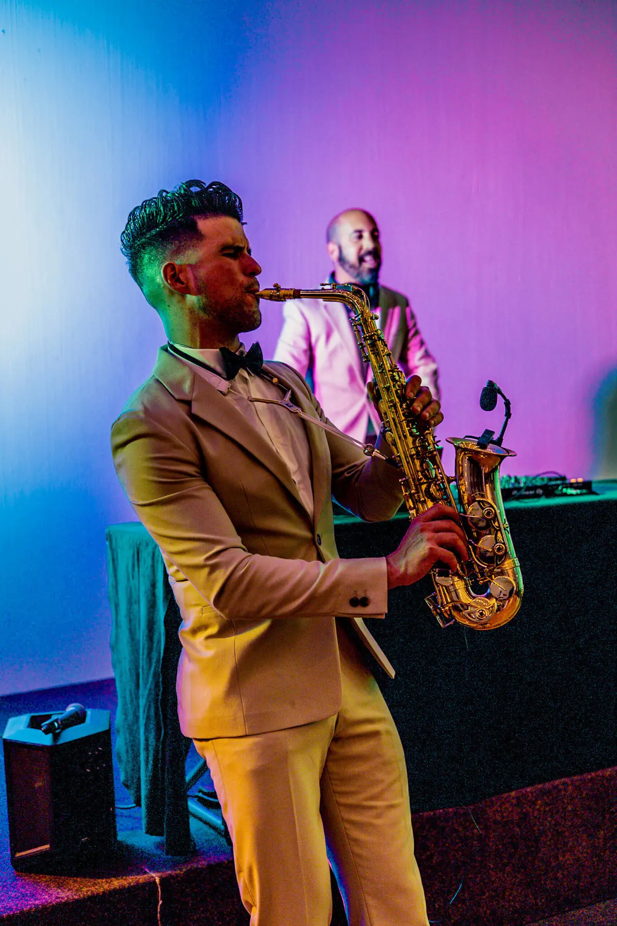 Saxophonist performing under coloured lights